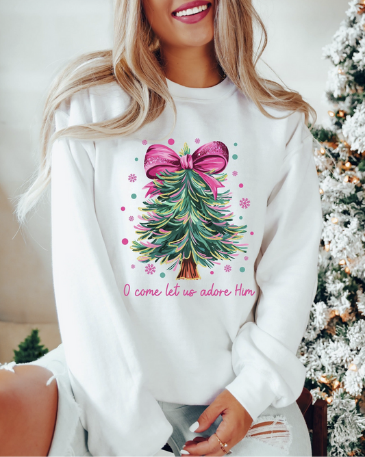 Woman wearing white O Come Let Us Adore Him Christmas sweatshirt with tree and bow design
 Christian holiday crewneck with festive Christmas tree graphic
 Faith-based sweatshirt perfect for church, gifts, and Christmas gatherings