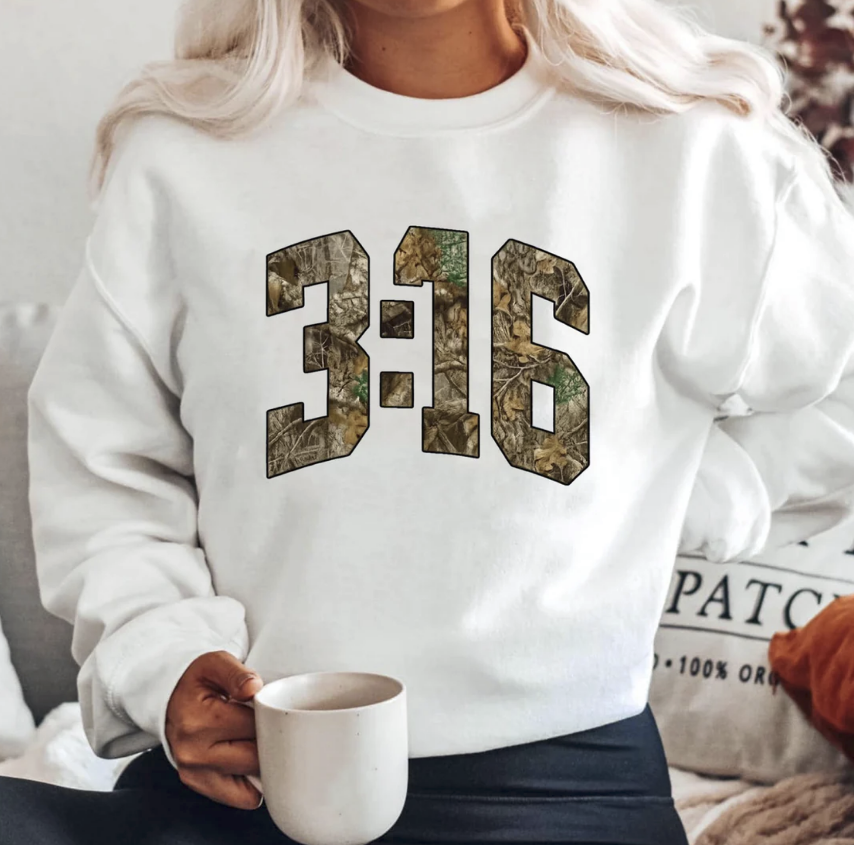 White Christian sweatshirt with bold 3:16 camo design

Faith-inspired crewneck for men and women in white

Bible verse John 3:16 apparel styled with coffee mug

Unisex Christian sweatshirt with camo print numbers