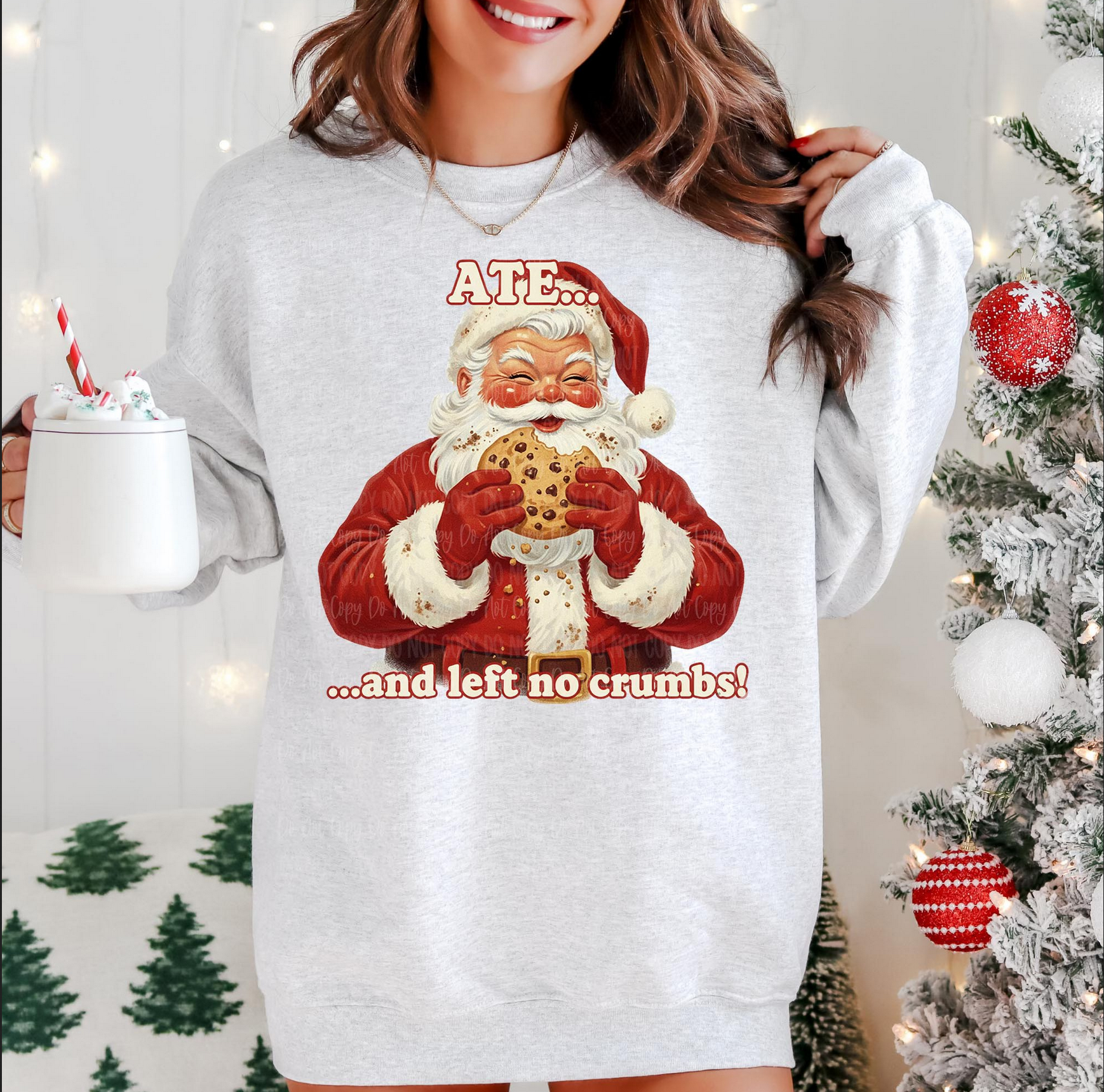 Woman wearing gray sweatshirt with vintage Santa eating a cookie and the words “Ate and left no crumbs.”

Close-up of retro Santa cookie design on Christmas sweatshirt.

Funny holiday crewneck with vintage Santa and cookie graphic.

Cozy festive sweatshirt styled for winter and Christmas season.