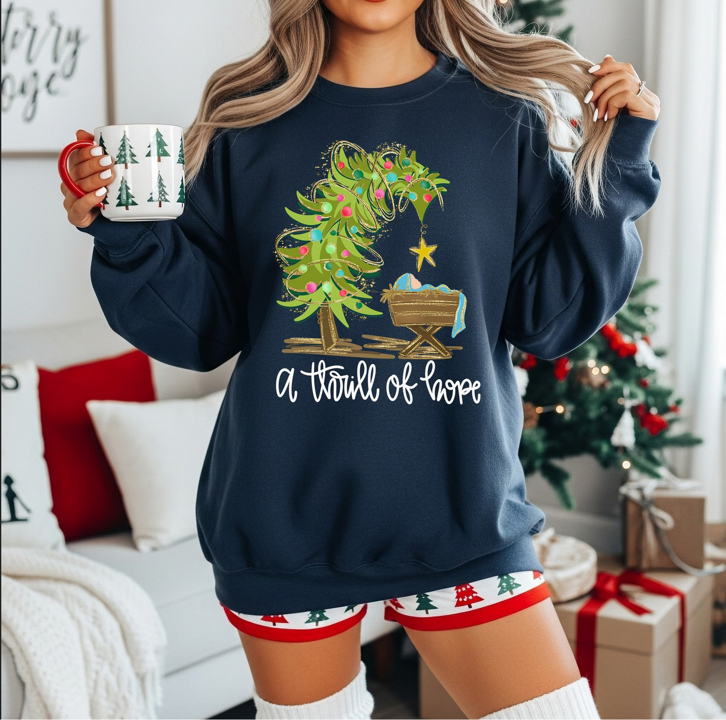 Woman wearing navy “A Thrill of Hope” nativity sweatshirt holding mug

Christian Christmas sweatshirt with tree and manger design

Cozy holiday faith-based crewneck in navy blue

Religious Christmas sweatshirt styled for winter