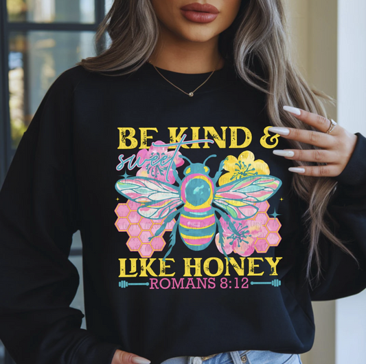 "Be Kind and Sweet Like Honey Christian sweatshirt with Romans 8:12"

"Black crewneck with colorful bee and honeycomb graphic"

"Inspirational Bible verse sweatshirt for Christian faith wear"