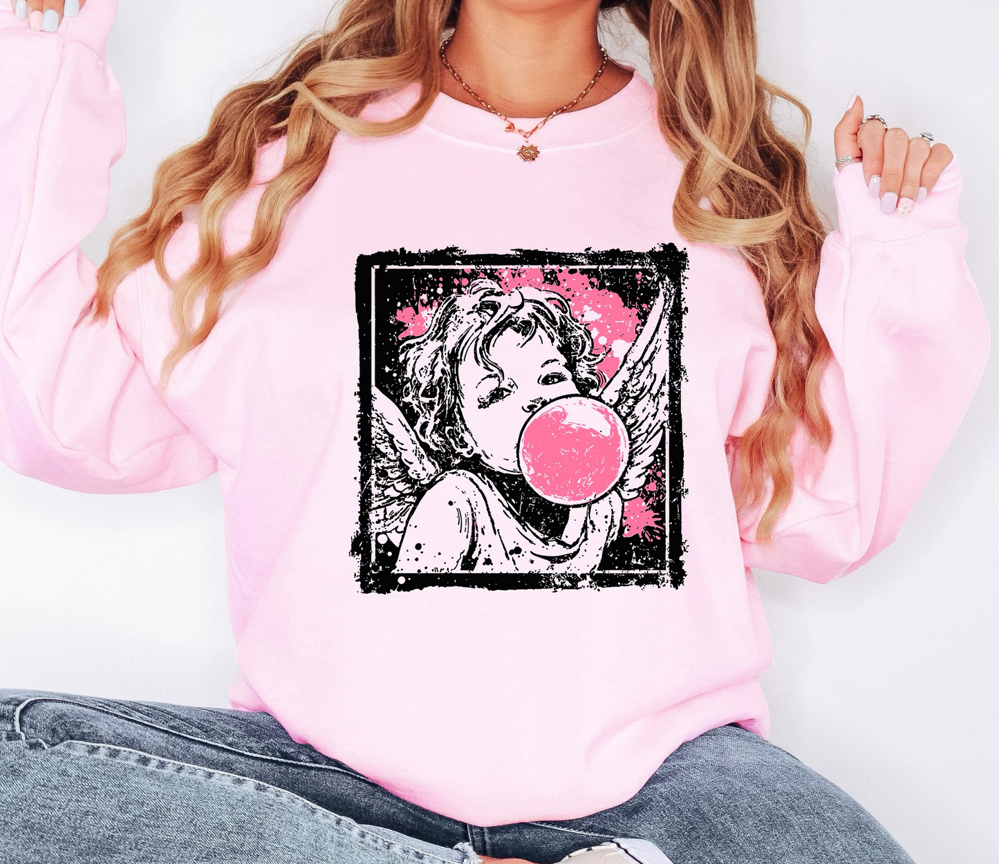Pink graphic sweatshirt featuring vintage-style angel blowing a bubblegum bubble