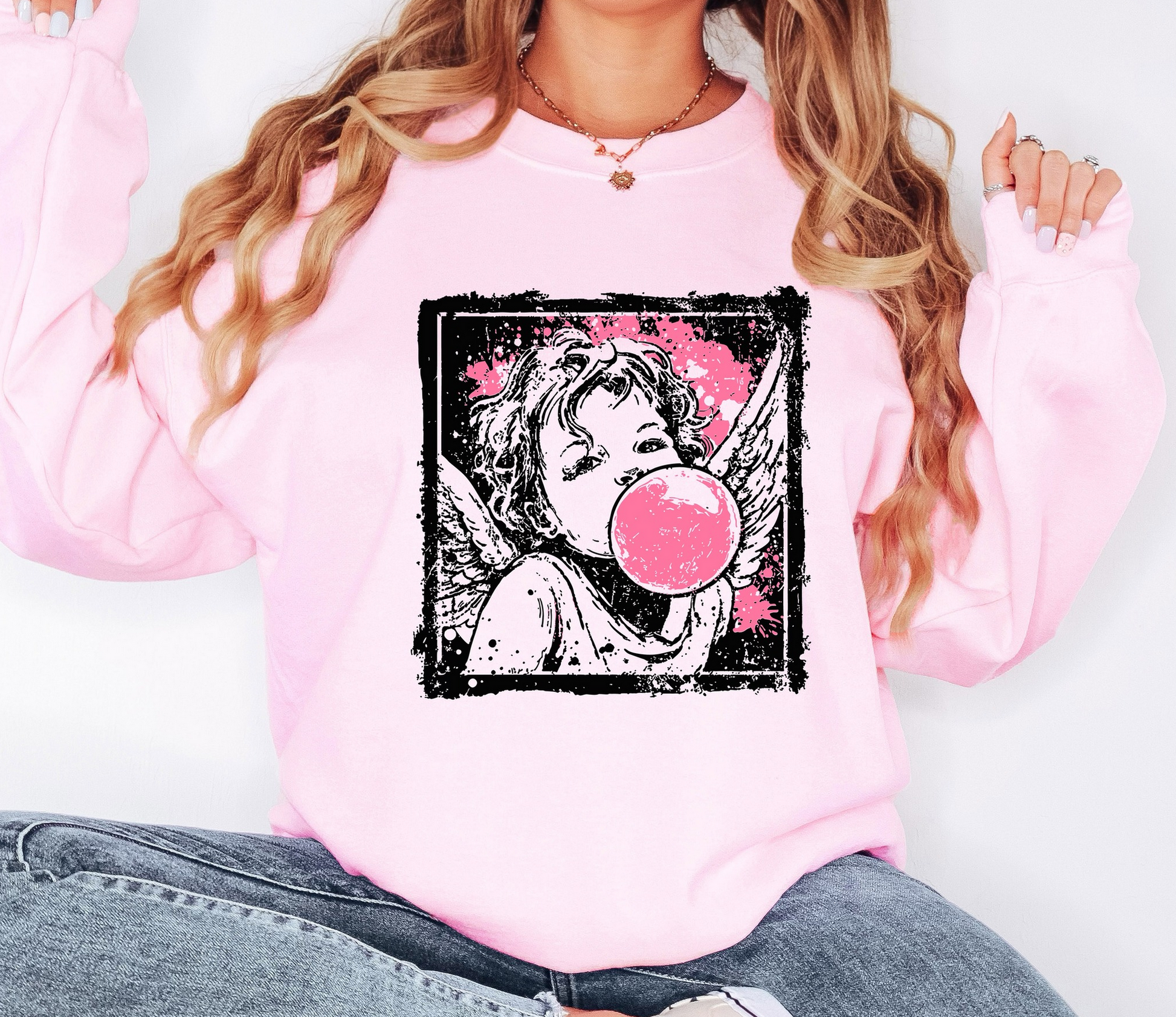 Pink graphic sweatshirt featuring vintage-style angel blowing a bubblegum bubble
