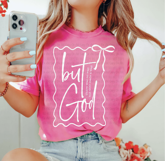 Pink t-shirt with white text “But God” and bow accent – inspirational Christian Bible verse faith tee