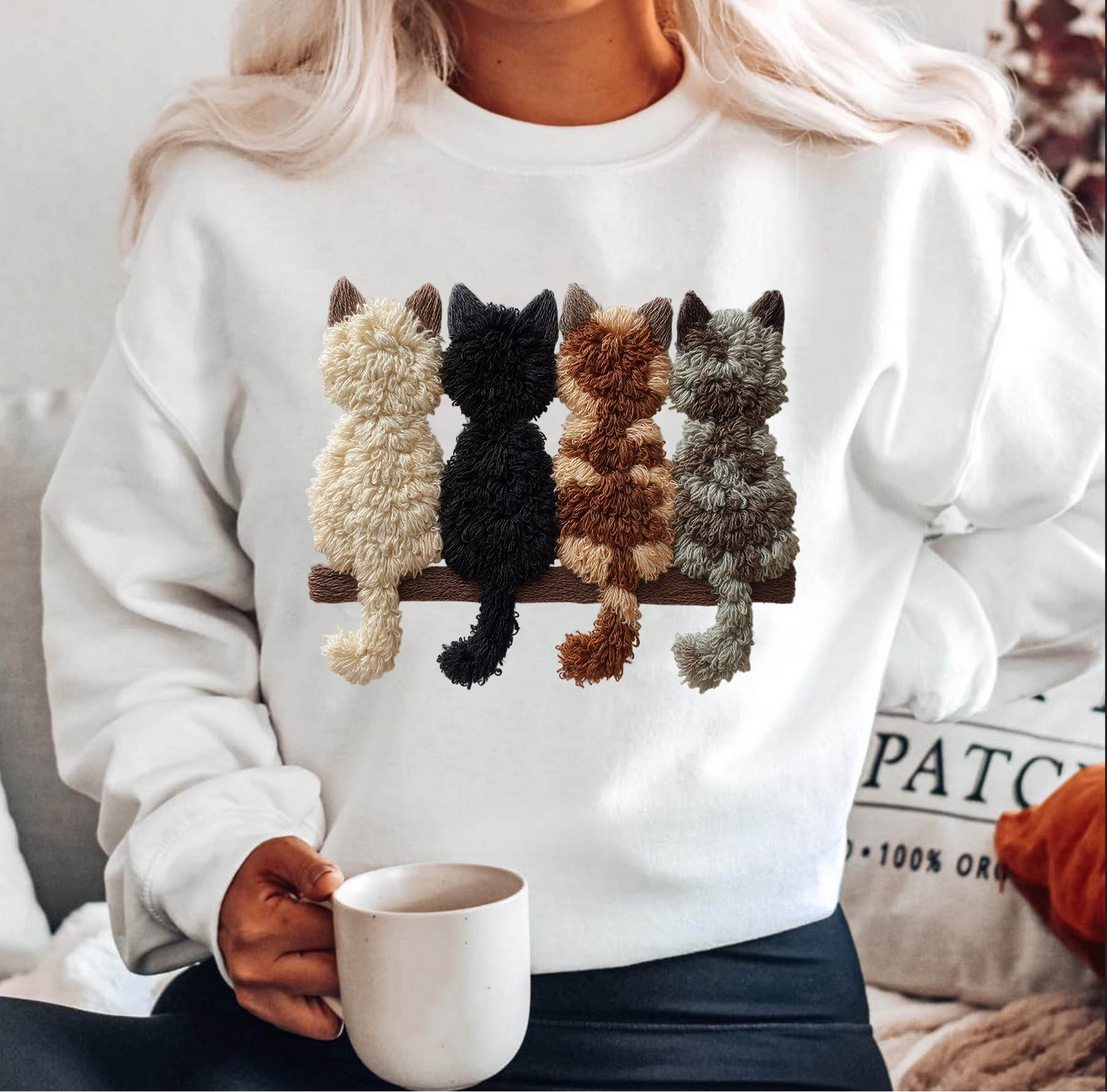 Woman wearing white sweatshirt with four fuzzy cats sitting on branch

Cozy neutral cat lover sweatshirt styled with mug

Cute fuzzy cat design on white crewneck

Cozy winter pullover — perfect cat mom gift