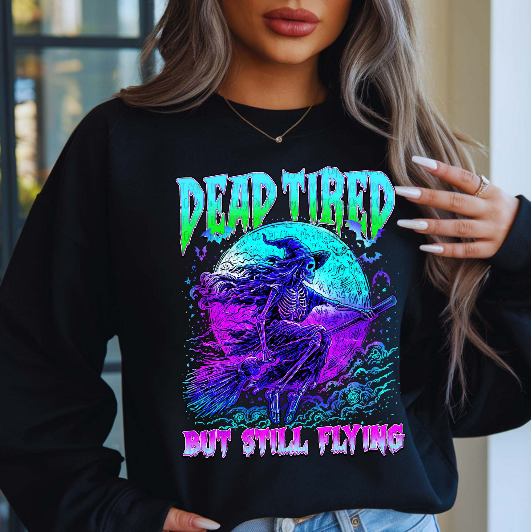 "Black sweatshirt with neon purple and blue skeleton witch flying on broomstick and text Dead Tired But Still Flying"