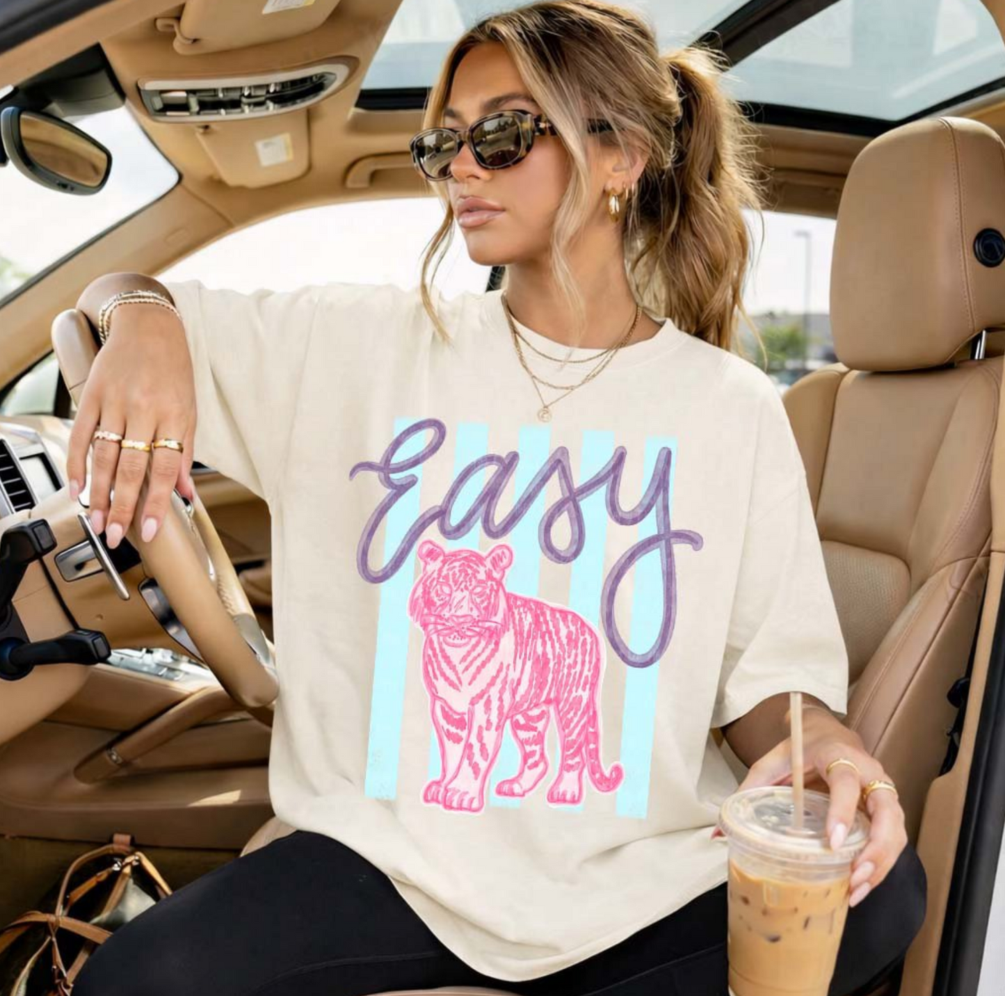 Image Alt Text:
Cream graphic t-shirt featuring pastel Easy Tiger lettering with a pink tiger design for trendy boutique casual fashion