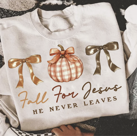 Image 1 (tee): Cream t-shirt with “Fall for Jesus He Never Leaves” design featuring pumpkins, bows, and autumn colors
Image 2 (sweatshirt): Beige sweatshirt with “Fall for Jesus He Never Leaves” design featuring gingham pumpkin and fall bows