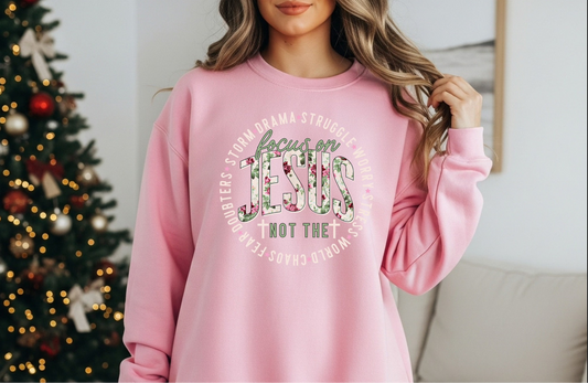 Woman wearing pink “Focus on Jesus” Christian sweatshirt

Inspirational faith sweatshirt with Bible verse theme

Cozy pink crewneck with “Focus on Jesus, not the storm” quote

Faith over fear sweatshirt perfect for church or casual wear
