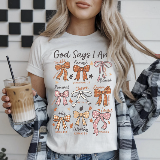 "God Says I Am Christian Bible verse graphic t-shirt with bows"

"Inspirational scripture affirmation tee for women"

"Christian unisex shirt with positive faith message"