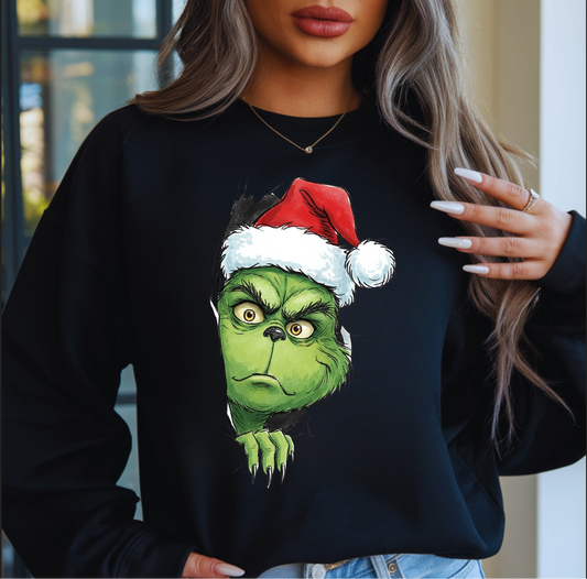 Woman wearing black sweatshirt with funny green holiday character

Funny Christmas crewneck with “Feelin’ Merry… ish” quote

Cozy holiday pullover perfect for grumpy Christmas mood

Festive black sweatshirt styled for winter season