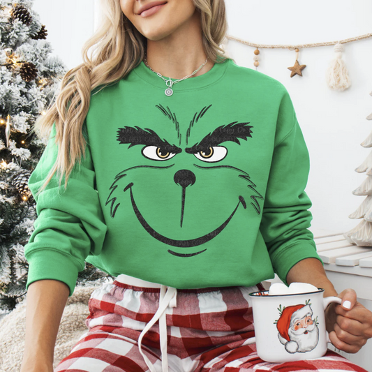 Woman wearing green Mr. Merry Mood sweatshirt holding mug

Funny Christmas sweatshirt with cheerful grumpy face design

Cozy green holiday crewneck styled for festive morning

Funny holiday pullover — perfect for Christmas humor