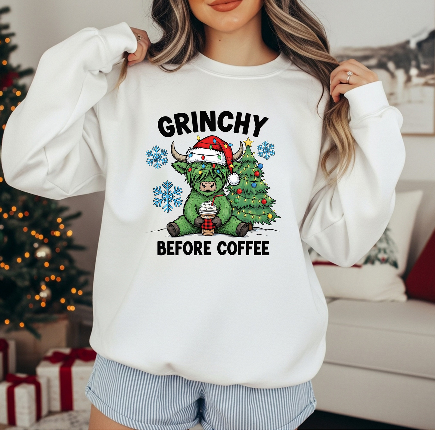 White sweatshirt with “Grinchy Before Coffee” and a grumpy green creature holding coffee.

Festive Christmas crewneck featuring cute green character and holiday tree.

Cozy holiday sweatshirt for coffee lovers with humorous design.

Woman wearing funny Christmas pullover with grumpy green creature graphic.