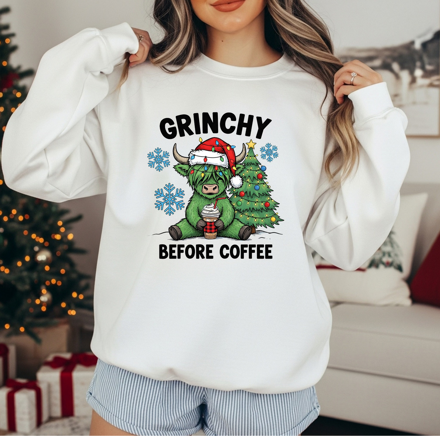 White sweatshirt with “Grinchy Before Coffee” and a grumpy green creature holding coffee.

Festive Christmas crewneck featuring cute green character and holiday tree.

Cozy holiday sweatshirt for coffee lovers with humorous design.

Woman wearing funny Christmas pullover with grumpy green creature graphic.