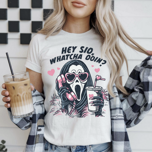 White graphic t-shirt with Ghostface wearing pink sunglasses, holding a phone and drink, and text “Hey Sid, Whatcha Doin?”