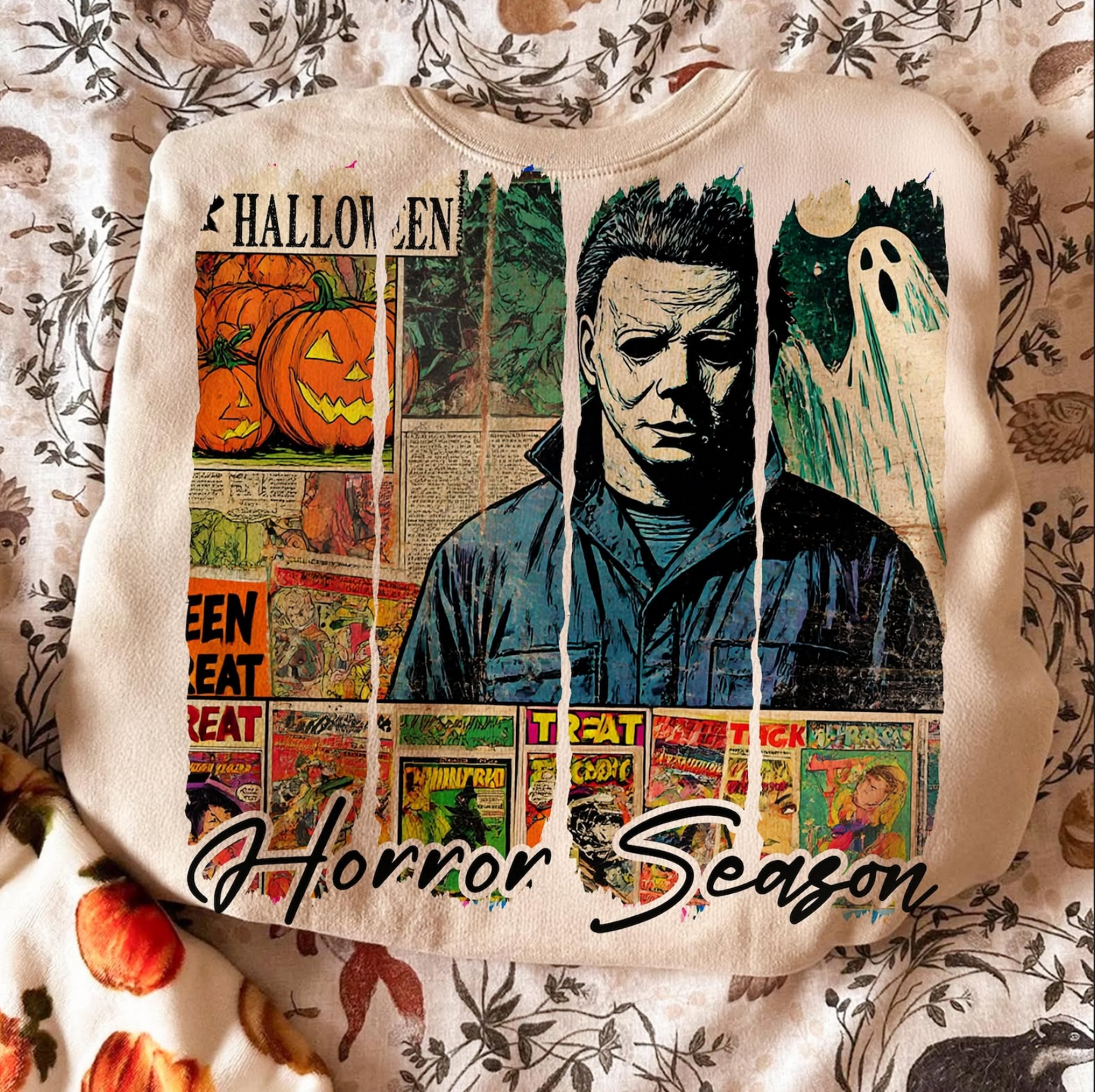 Vintage horror themed sweatshirt featuring pumpkins, ghost artwork, retro comic collage design, and Horror Season text.