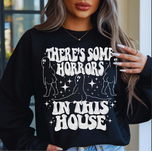 There's Some Horrors in This House graphic sweatshirt with ghost designs on black pullover
