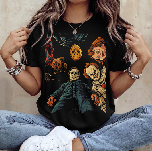 Woman wearing black graphic tee featuring Michael Myers, Jason Voorhees, Freddy Krueger, and Pennywise – horror villains Halloween t-shirt
