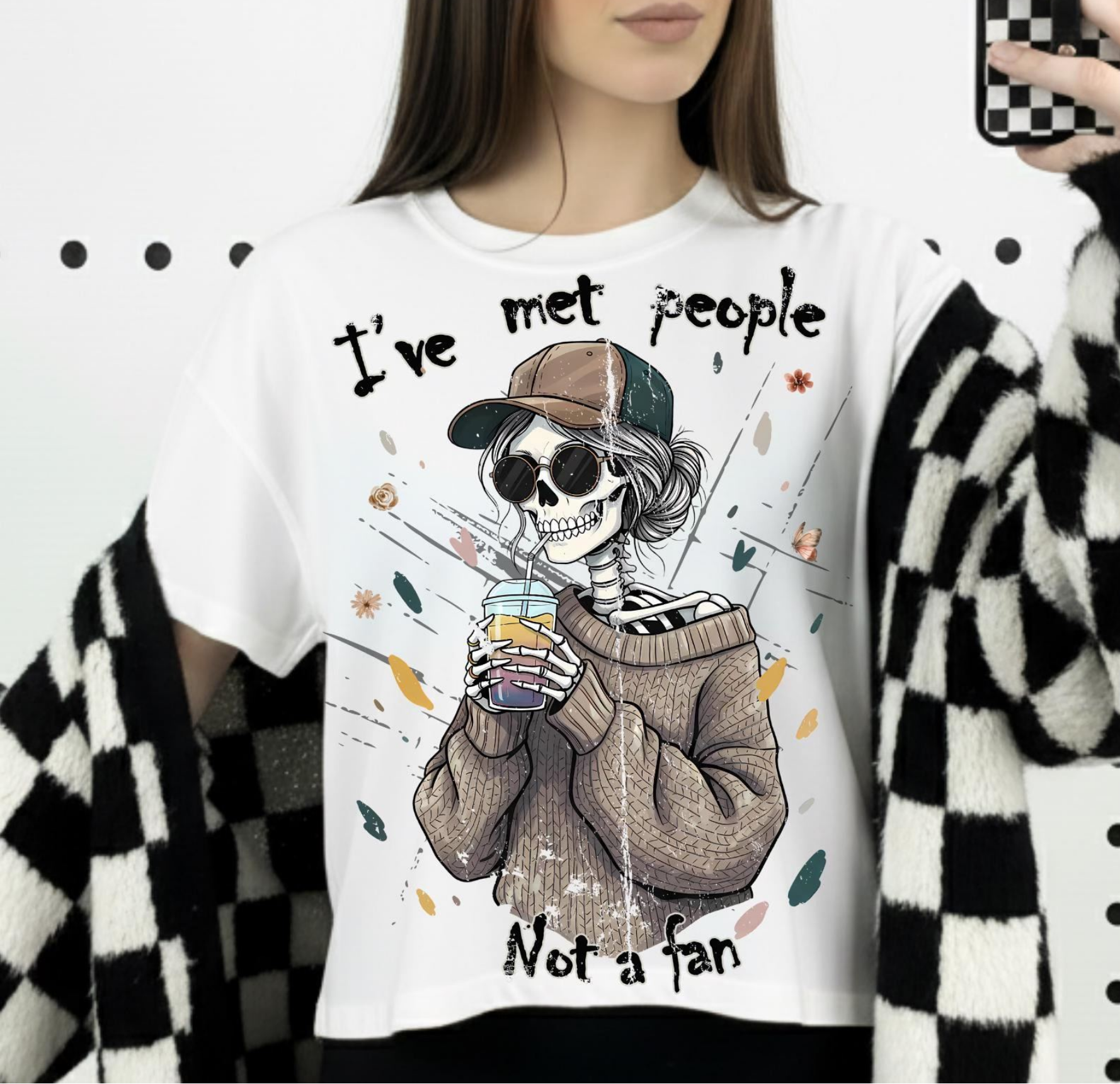 White graphic t-shirt featuring skeleton in sweater holding coffee with Ive met people not a fan phrase for funny introvert aesthetic fashion