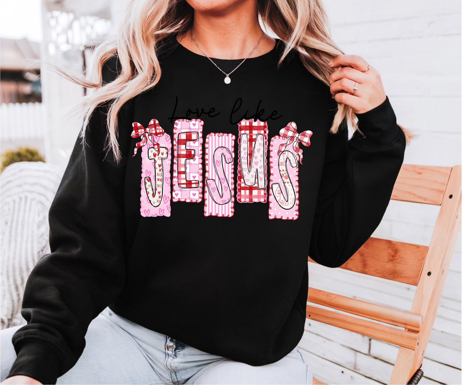 Black Love Like Jesus graphic sweatshirt featuring pink bow and heart patch-style lettering