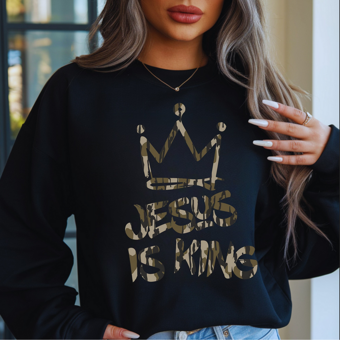 Woman wearing black Jesus Is King sweatshirt with gold crown design

Christian faith sweatshirt with metallic-style lettering

Cozy unisex black crewneck styled for winter

Inspirational Jesus Is King pullover — faith-based outfit