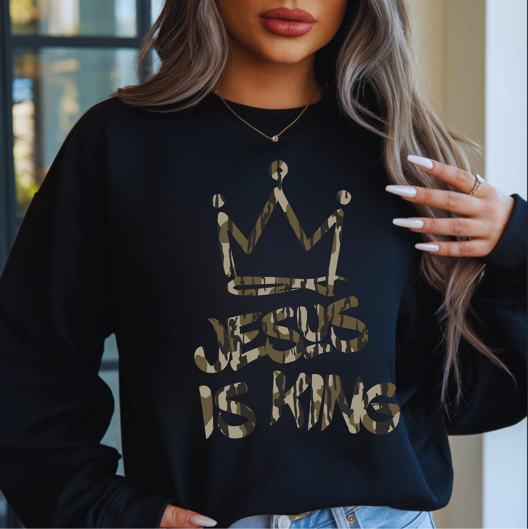 Woman wearing black Jesus Is King sweatshirt with gold crown design

Christian faith sweatshirt with metallic-style lettering

Cozy unisex black crewneck styled for winter

Inspirational Jesus Is King pullover — faith-based outfit