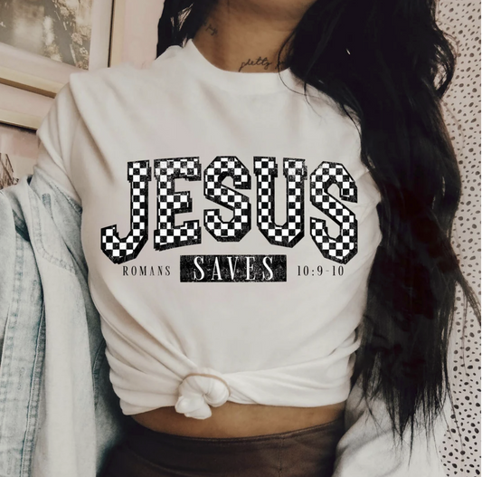"Jesus Saves t-shirt with Romans 10:9-10 scripture graphic"

"Christian faith tee with checkerboard Jesus lettering"

"Bold black and white Christian graphic t-shirt unisex"