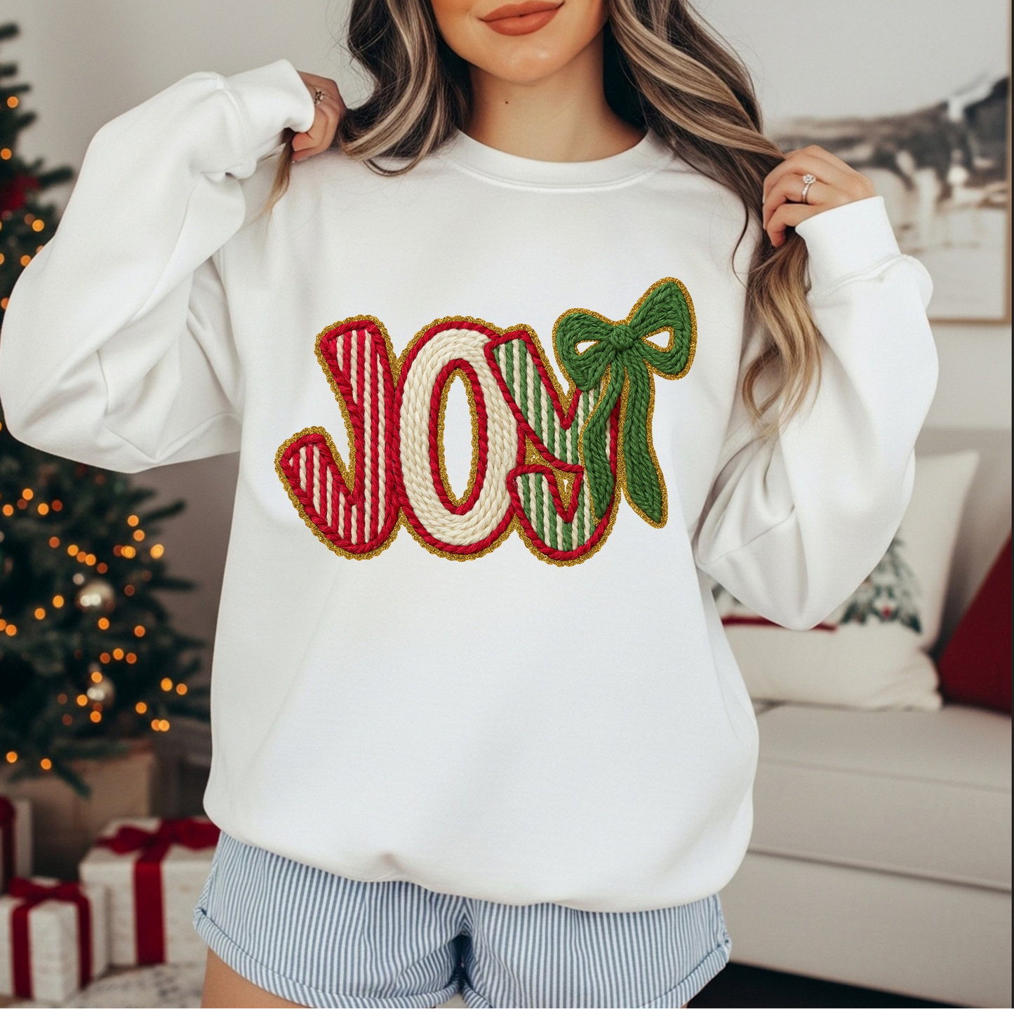 White sweatshirt with knit-style JOY lettering and green bow design.

Holiday crewneck featuring JOY text in red and green Christmas colors.

Cozy winter sweatshirt with festive JOY graphic.

Woman wearing white JOY Christmas sweater in holiday setting.