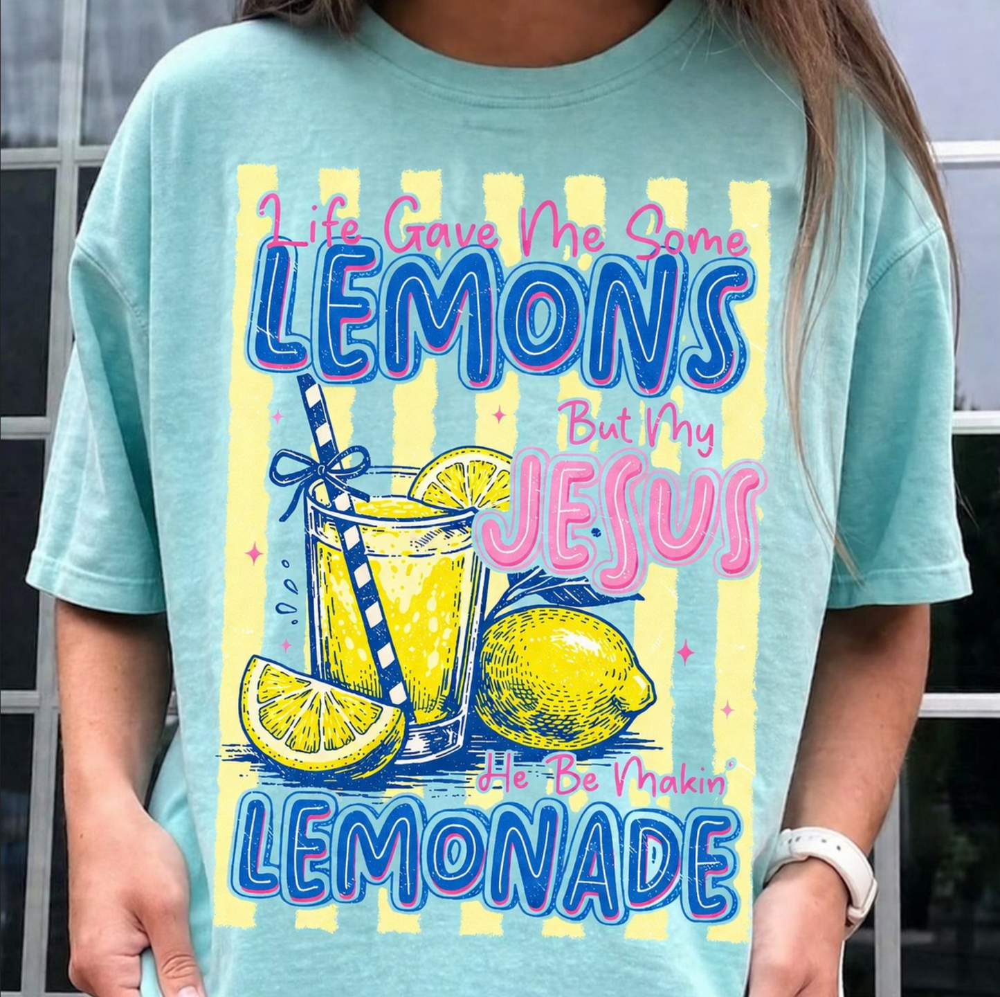 Teal graphic t-shirt featuring Life Gave Me Lemons Jesus Made Lemonade design with lemons and lemonade illustration for faith-based boutique fashion