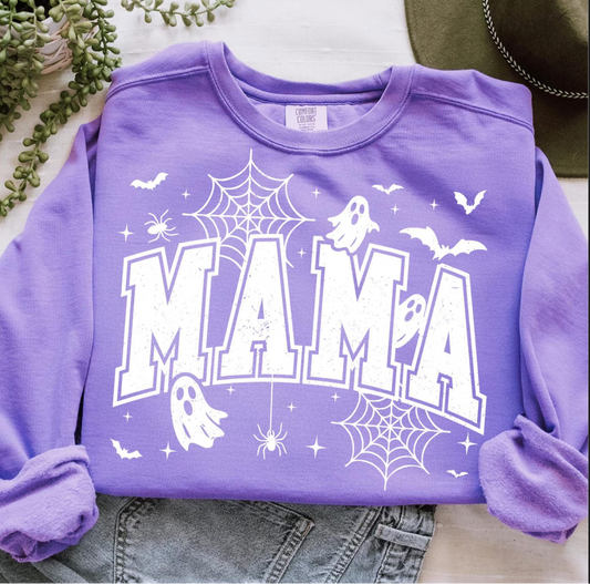 Purple crewneck sweatshirt with large white “MAMA” varsity lettering decorated with ghosts, spider webs, bats, and stars.