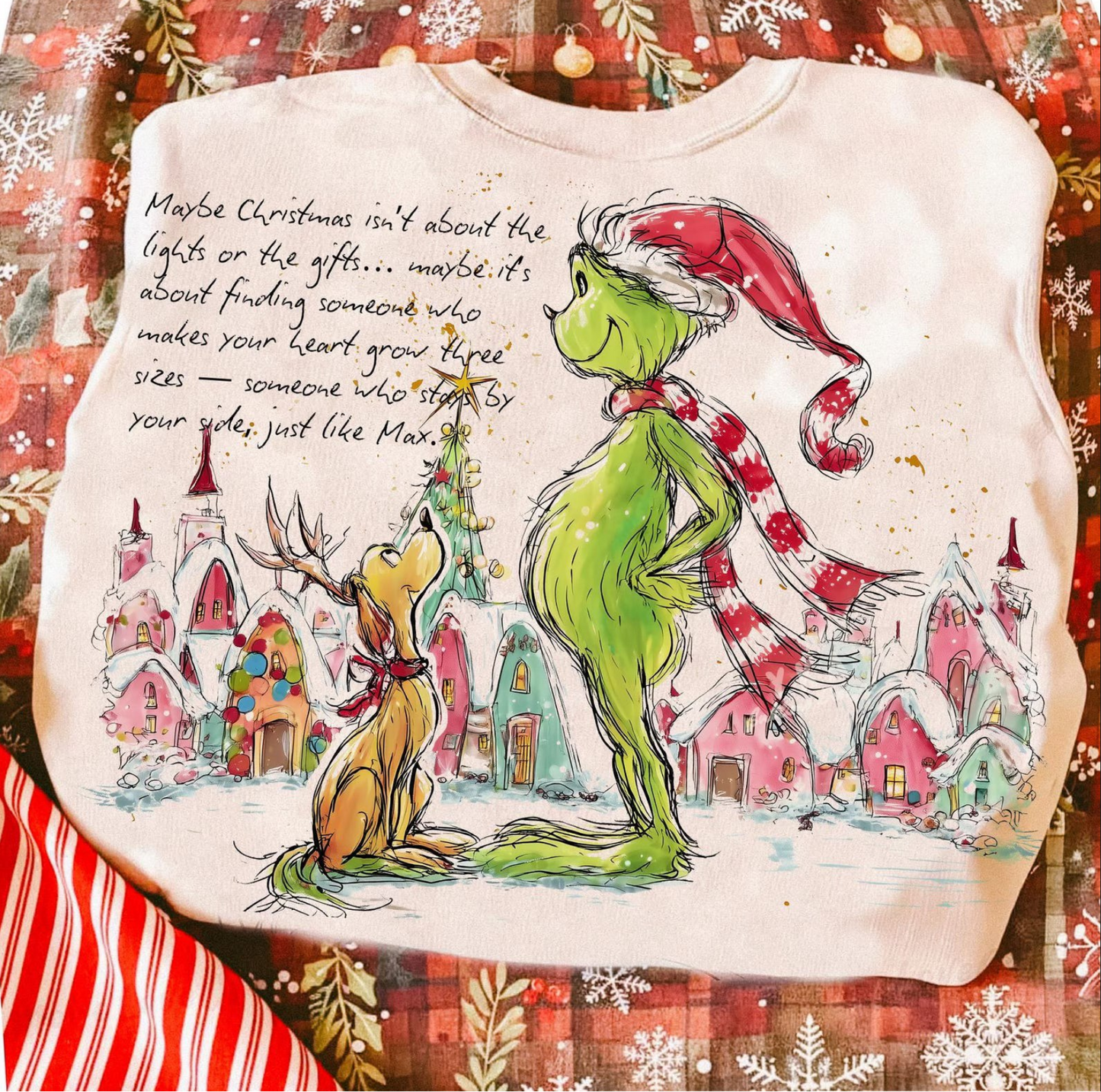 Cozy holiday sweatshirt featuring a green whimsical creature and dog in a snowy Christmas village

Neutral Christmas crewneck with heartwarming “Maybe Christmas Isn’t About the Gifts” quote

Festive winter sweatshirt with cozy character art and inspirational holiday message

Cream-colored Christmas pullover styled for holiday season