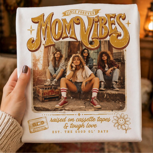 Cream graphic t-shirt featuring Mom Vibes vintage design with cassette tape and retro style elements for nostalgic boutique fashion