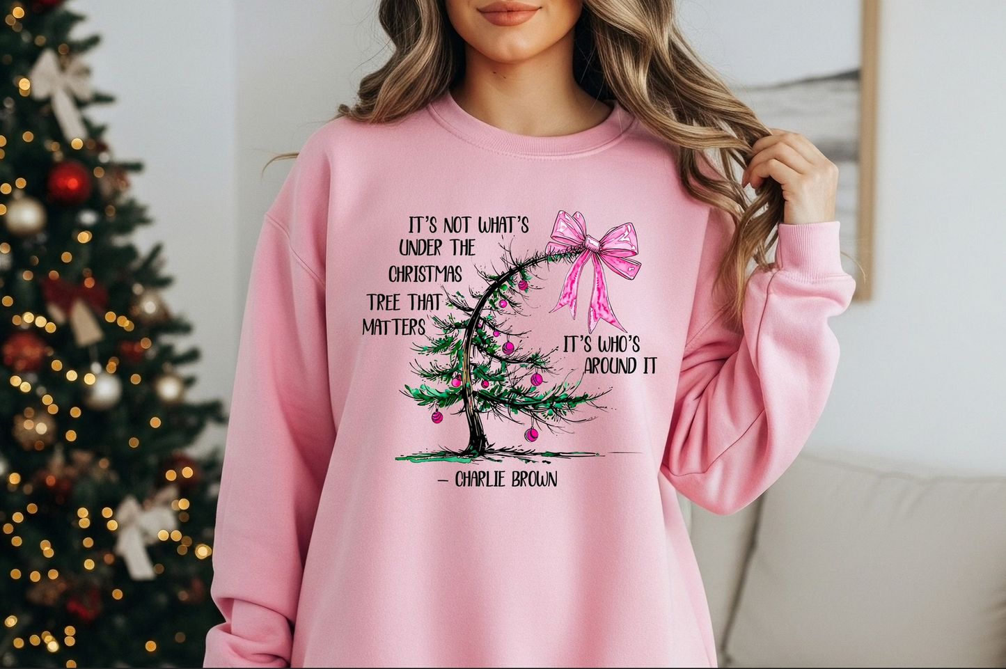 Pink sweatshirt with minimalist holiday tree design and inspirational Christmas quote.