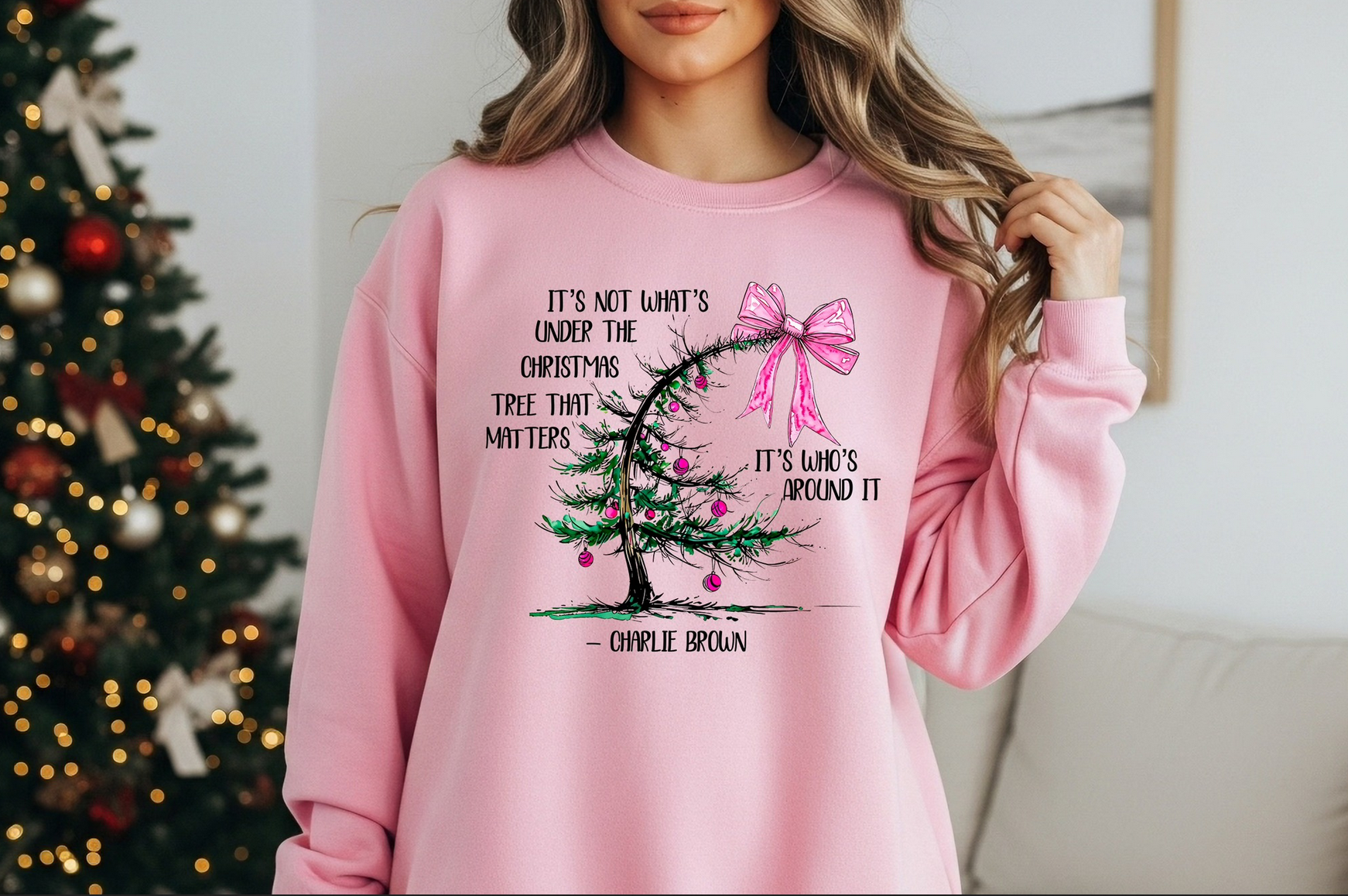 Pink sweatshirt with minimalist holiday tree design and inspirational Christmas quote.