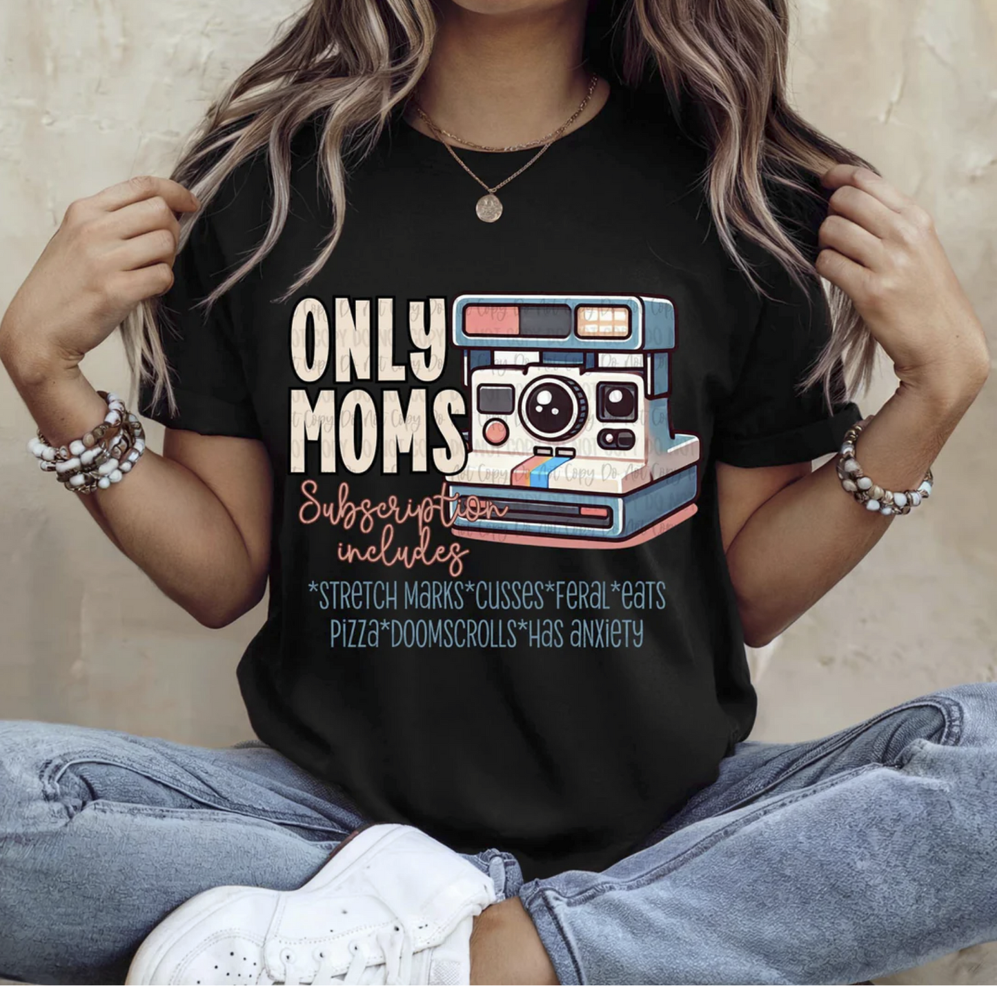 Black tee with “Only Moms Subscription Includes…” graphic design and vintage camera illustration.

Funny motherhood humor shirt with text about stretch marks, pizza, doomscrolling, and anxiety.