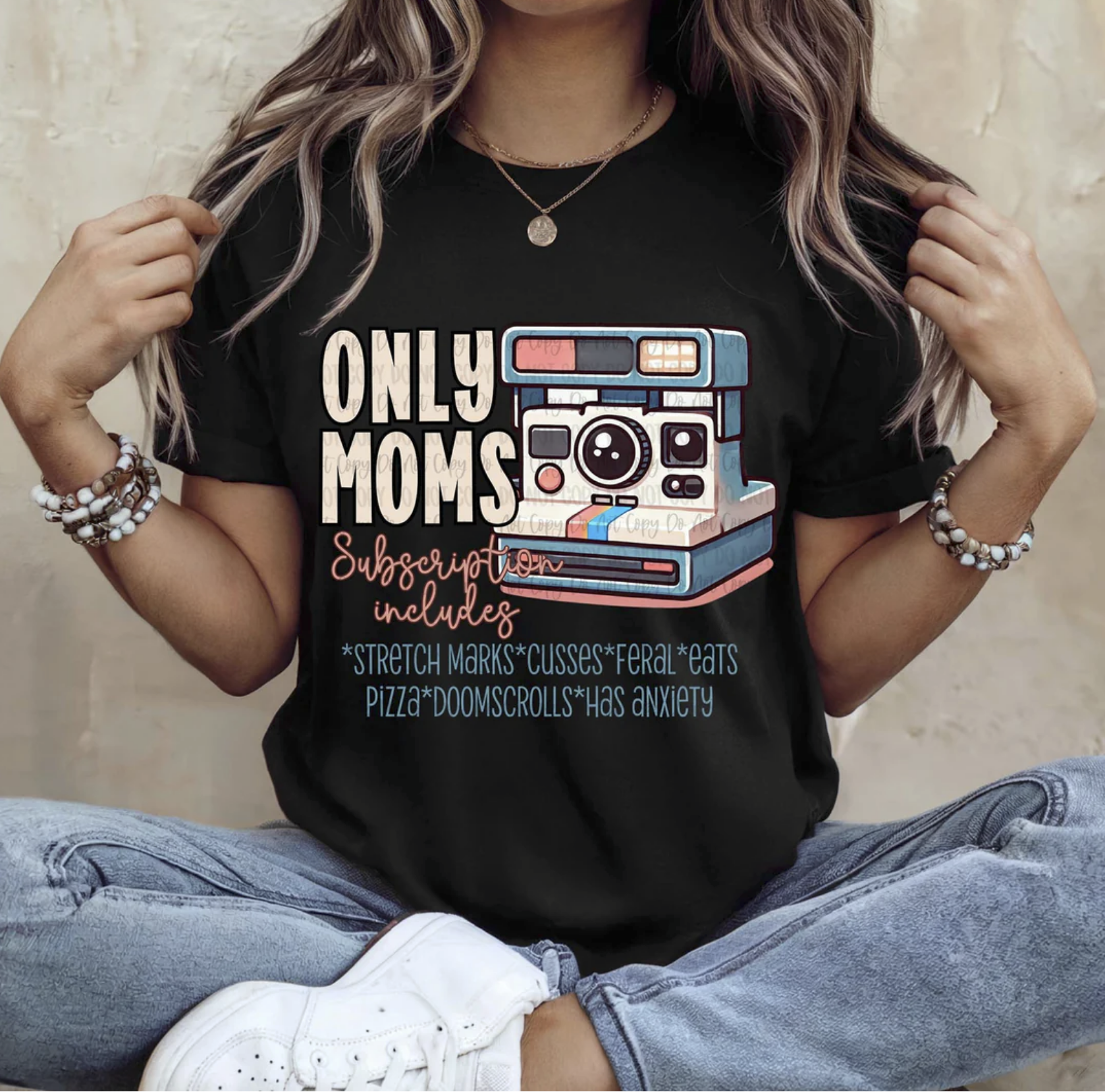 Black tee with “Only Moms Subscription Includes…” graphic design and vintage camera illustration.

Funny motherhood humor shirt with text about stretch marks, pizza, doomscrolling, and anxiety.