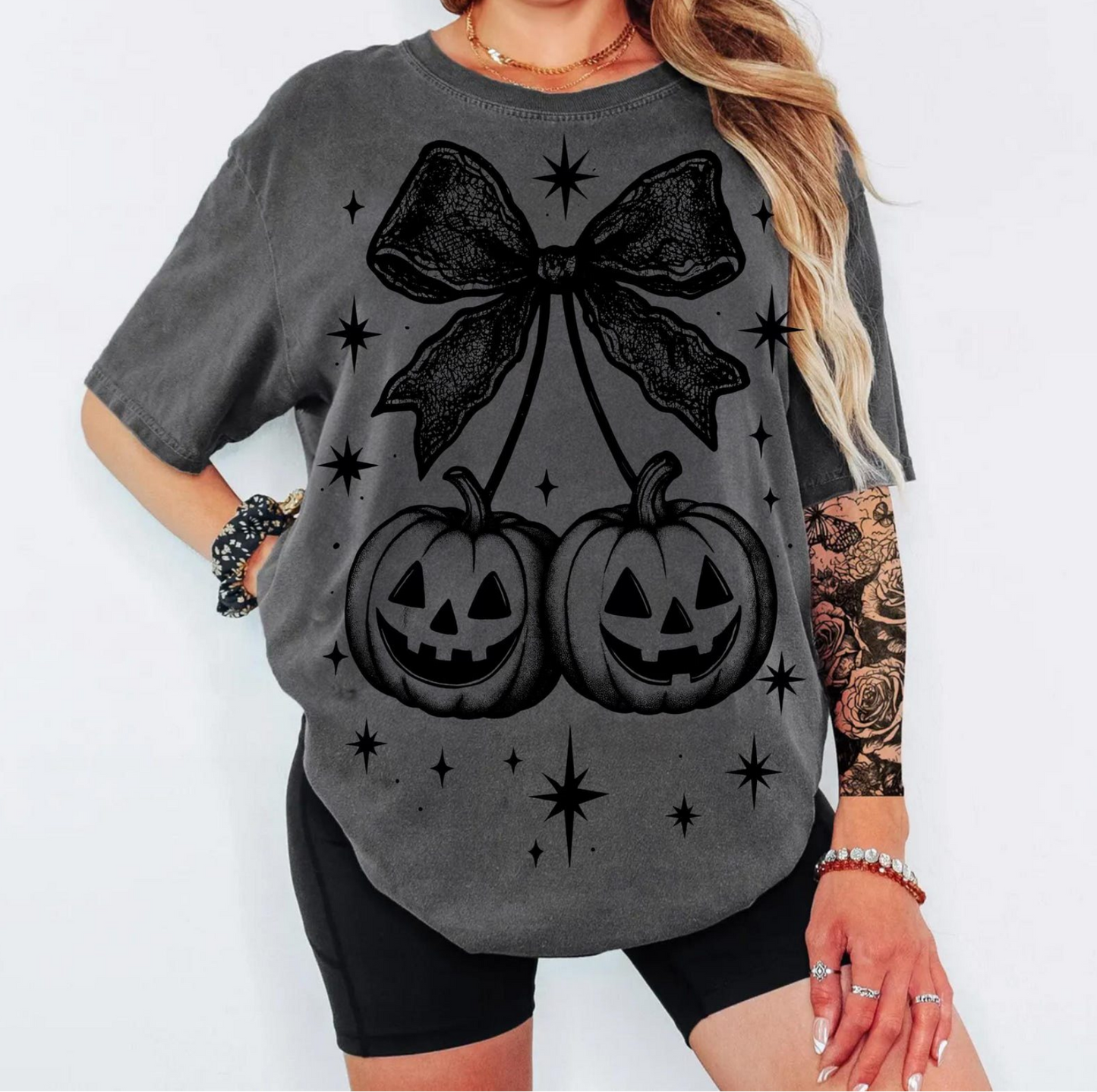 Gothic Pumpkin Bow T-Shirt with black jack-o’-lanterns and lace bow design – spooky Halloween graphic tee