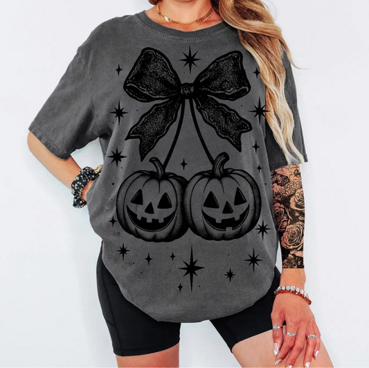 Gothic Pumpkin Bow T-Shirt with black jack-o’-lanterns and lace bow design – spooky Halloween graphic tee