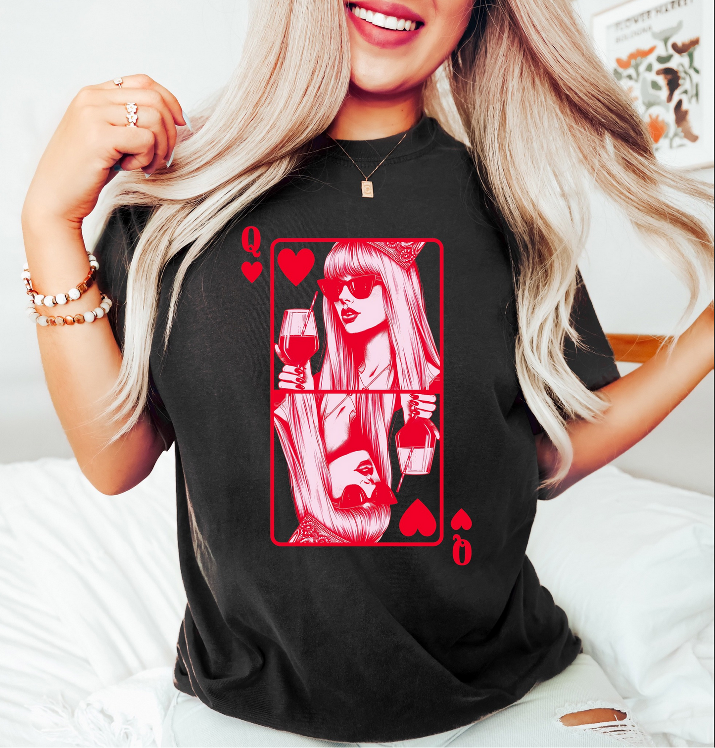 Black graphic t-shirt featuring red queen of hearts playing card–inspired wine illustration