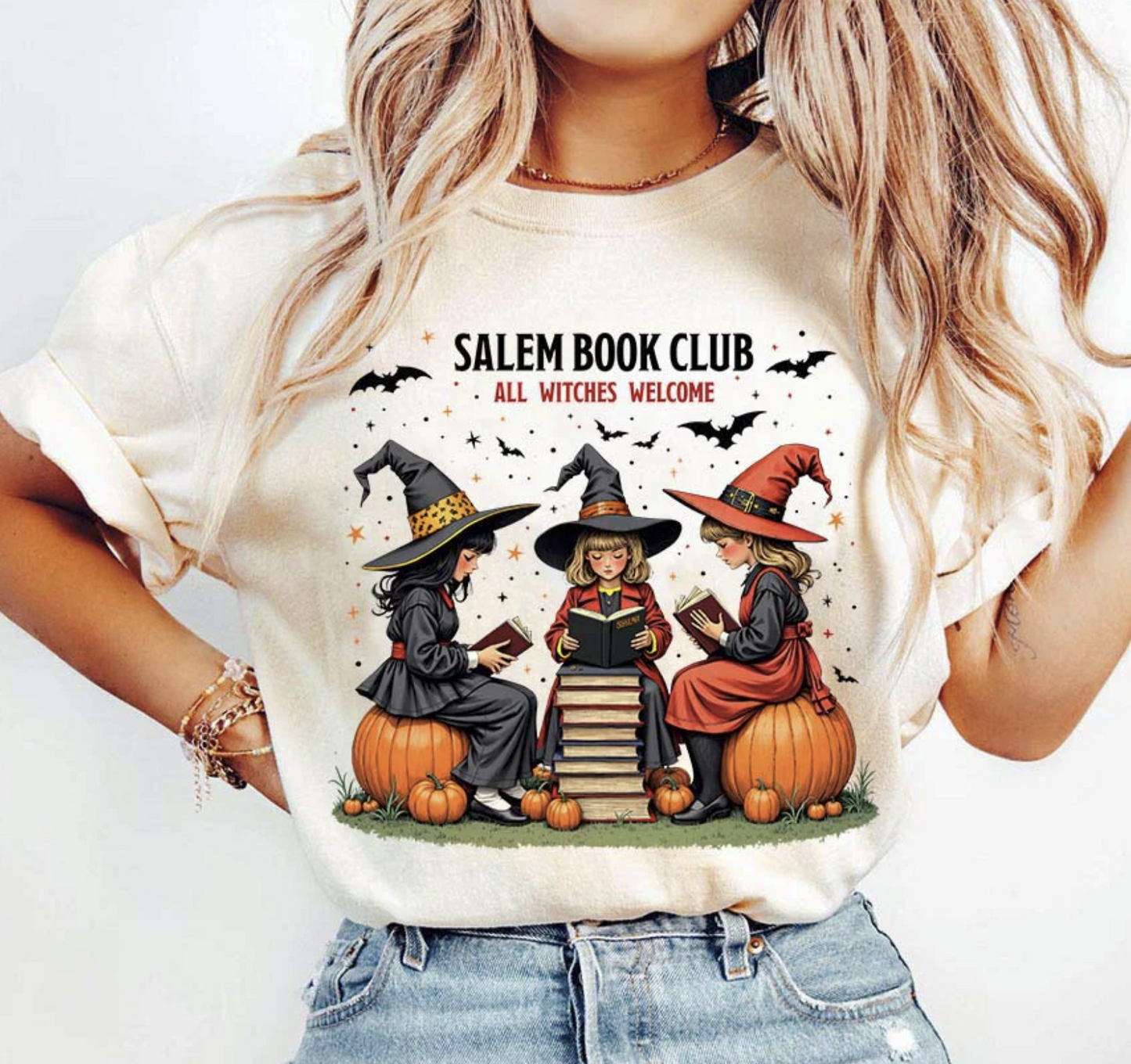 Salem Book Club Witches Graphic Tee – cozy Halloween t-shirt with three witches reading on pumpkins