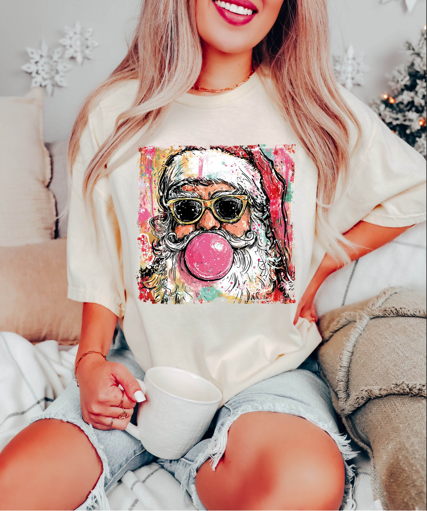 Beige tee with retro painted bubblegum Santa graphic.

Christmas T-shirt showing Santa blowing bubblegum and wearing sunglasses.

Trendy holiday tee with colorful Santa artwork.

Woman wearing oversized bubblegum Santa shirt indoors.