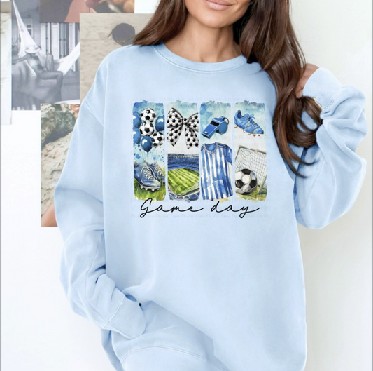 Light blue unisex sweatshirt with soccer-themed graphic panels and script text that reads ‘Game Day.
