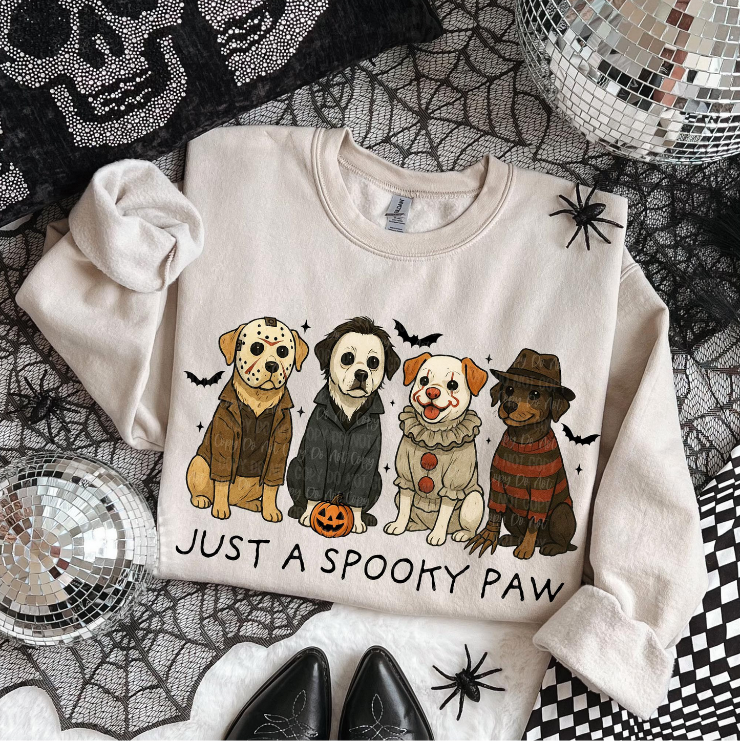"Beige Halloween sweatshirt with cartoon dogs dressed as horror movie characters and text Just a Spooky Paw"