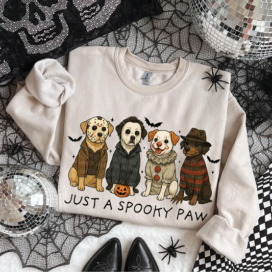 "Beige Halloween sweatshirt with cartoon dogs dressed as horror movie characters and text Just a Spooky Paw"
