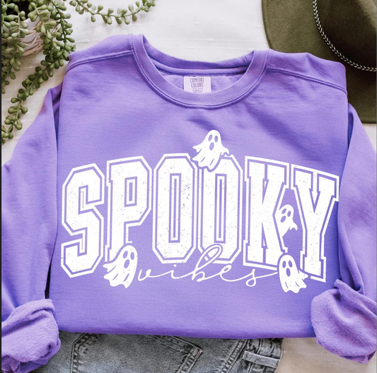 Purple crewneck sweatshirt with bold white varsity-style “Spooky Vibes” lettering and small ghost graphics.