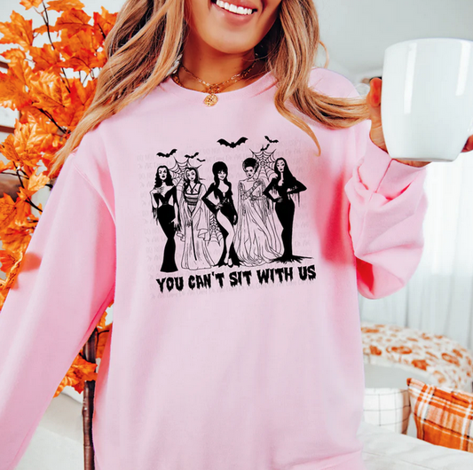 You Can’t Sit With Us Halloween sweatshirt with horror queens graphic"

"Spooky pink crewneck sweater for Halloween season"

"Funny gothic Halloween sweatshirt with creepy characters"