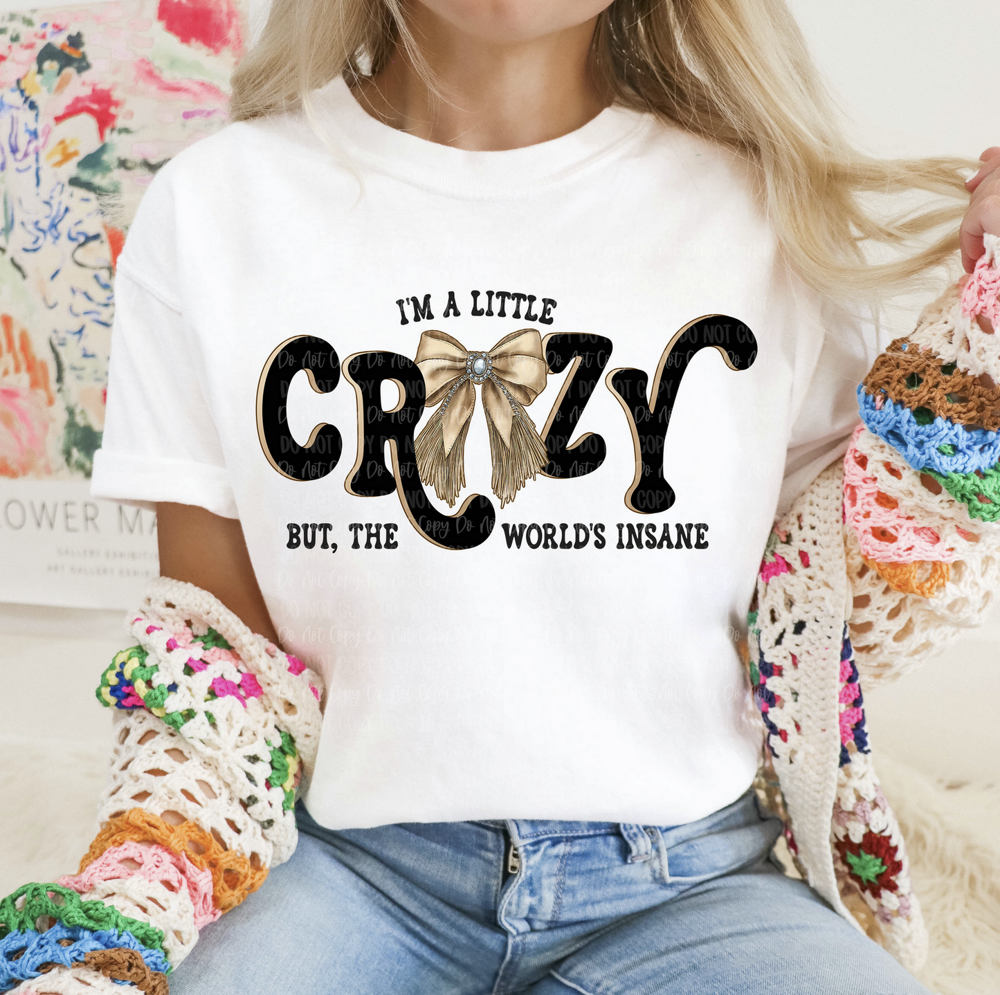I'm a Little Crazy but the World's Insane graphic tee with bow design on white shirt
