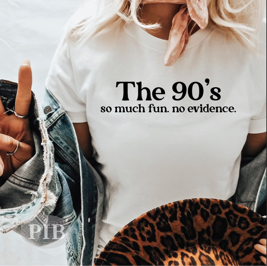 White graphic t-shirt with bold black text reading “The 90’s – so much fun. no evidence.”