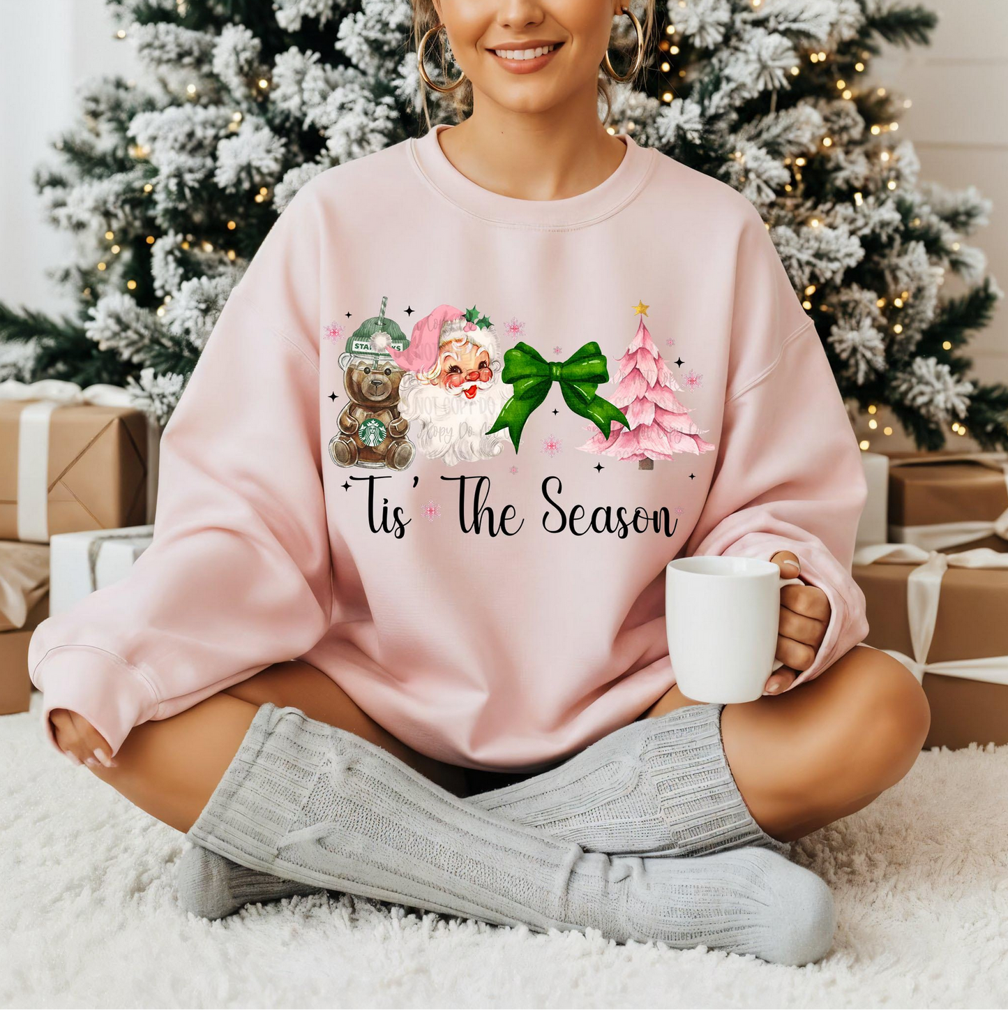 Woman wearing pink “Tis the Season” Christmas sweatshirt with Santa, bear mug, bow, and pink tree

Cozy pink holiday crewneck with vintage festive artwork

Cute Christmas sweatshirt styled for winter mornings

Girly holiday pullover with soft pink festive design