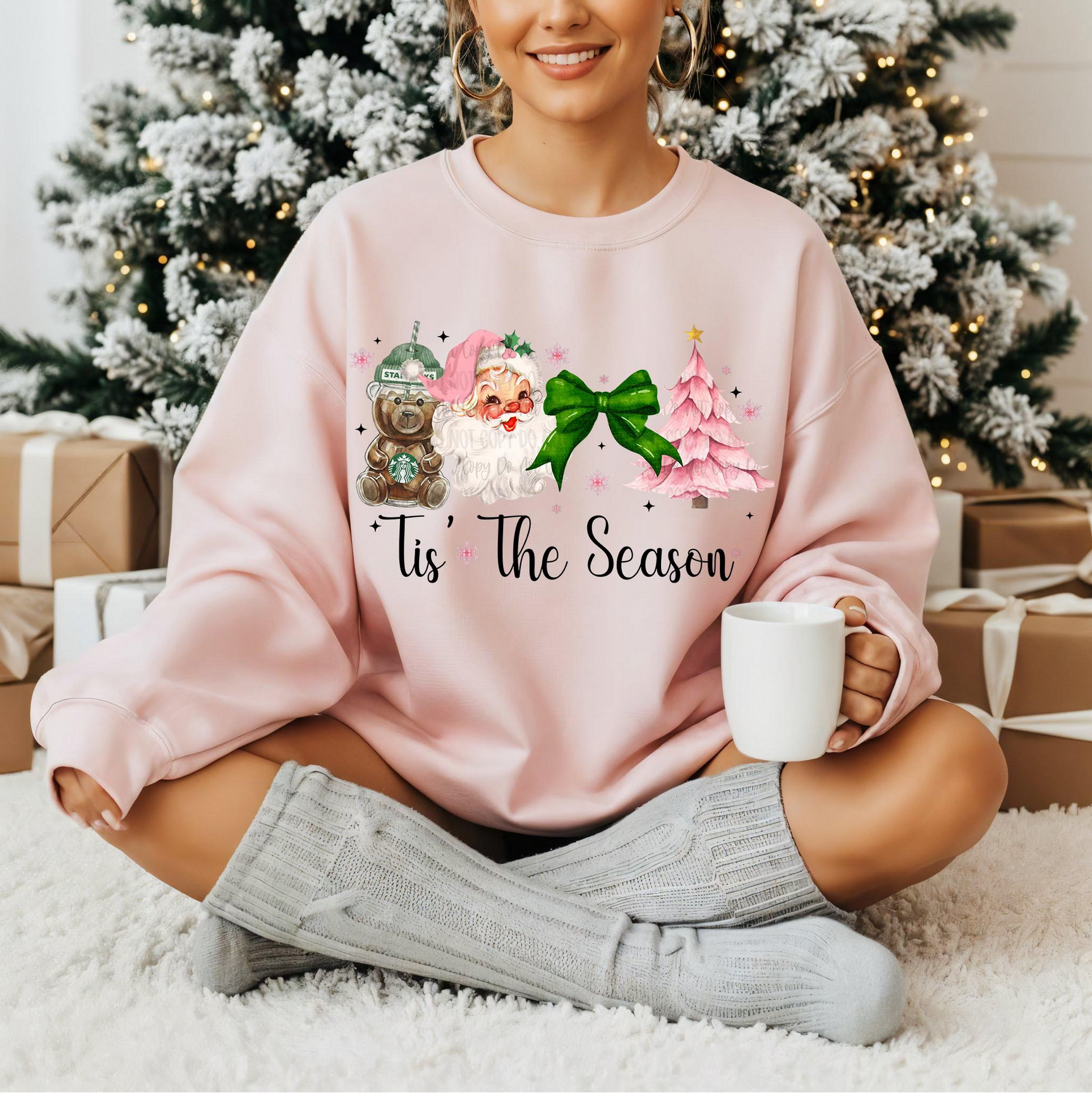 Woman wearing pink “Tis the Season” Christmas sweatshirt with Santa, bear mug, bow, and pink tree

Cozy pink holiday crewneck with vintage festive artwork

Cute Christmas sweatshirt styled for winter mornings

Girly holiday pullover with soft pink festive design